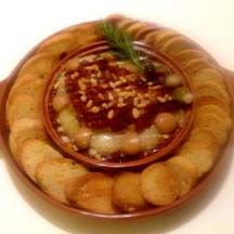 Baked Brie With Roasted Garlic And Sun-Dried Tomatoes recipe